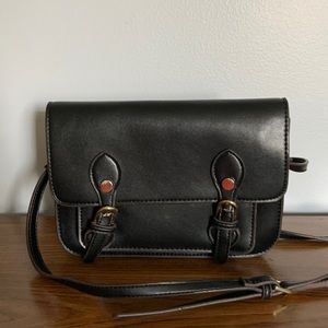 Smaller cross body black bag. Snap closure fully lined